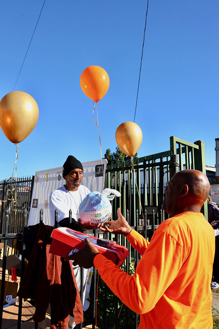 man handing out food