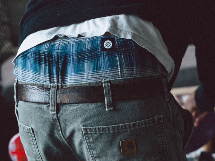 photo of a man wearing stance boxer briefs under a pair of jeans with a belt.