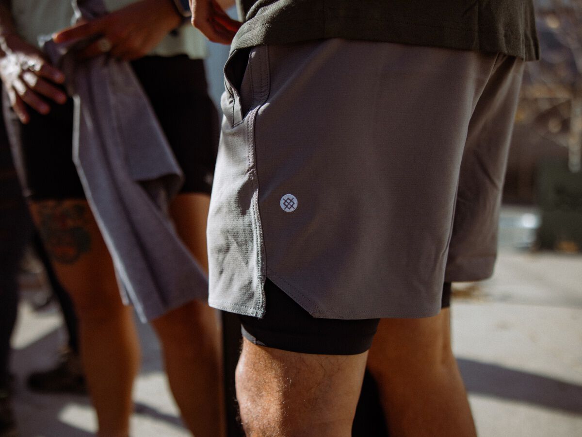 zoomed in photo of a person wearing grey complex shorts.