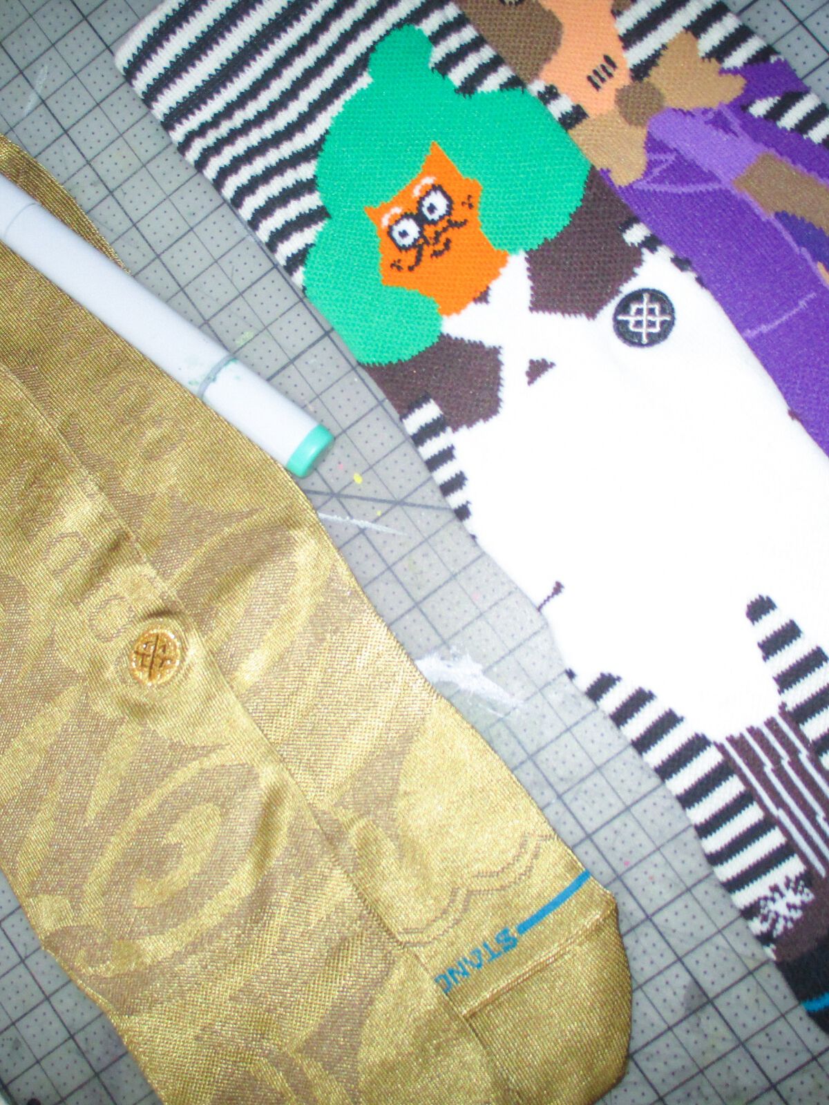 Willy Wonka x Stance socks layered on top of a grid background