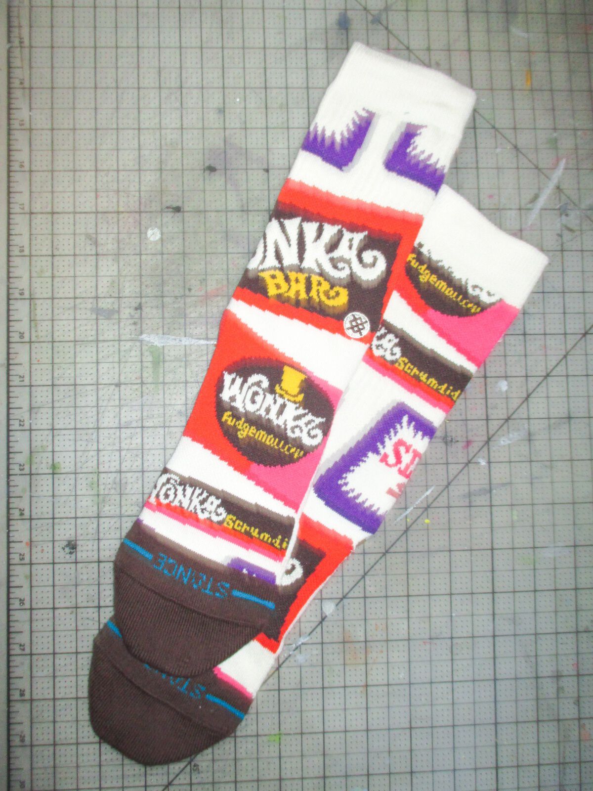 Willy Wonka x Stance socks layered on top of a grid background