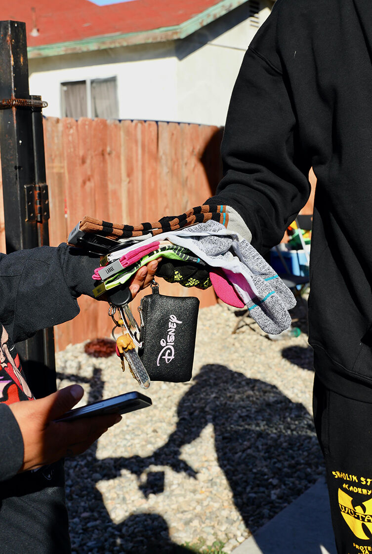 man handing someone socks